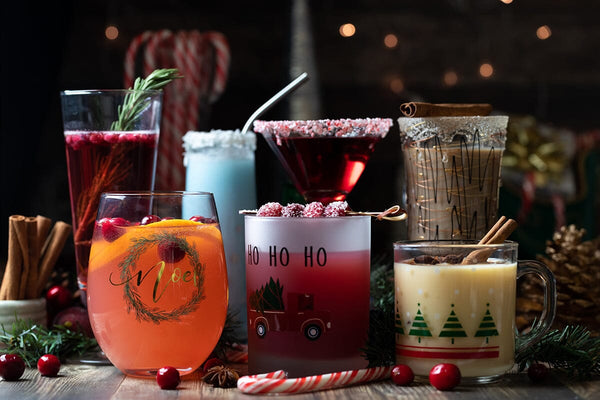 Front facing view of several cocktails against a festive dark background-Bottle Barn